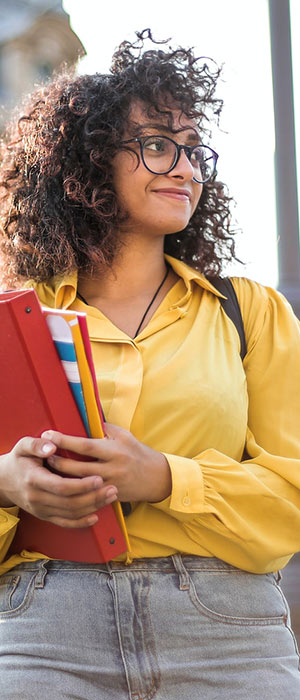 College woman holding notebooks.