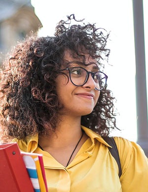 College woman holding notebooks.